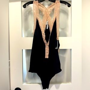 Free People women’s bodysuit never worn. Snap crotch. New with tags